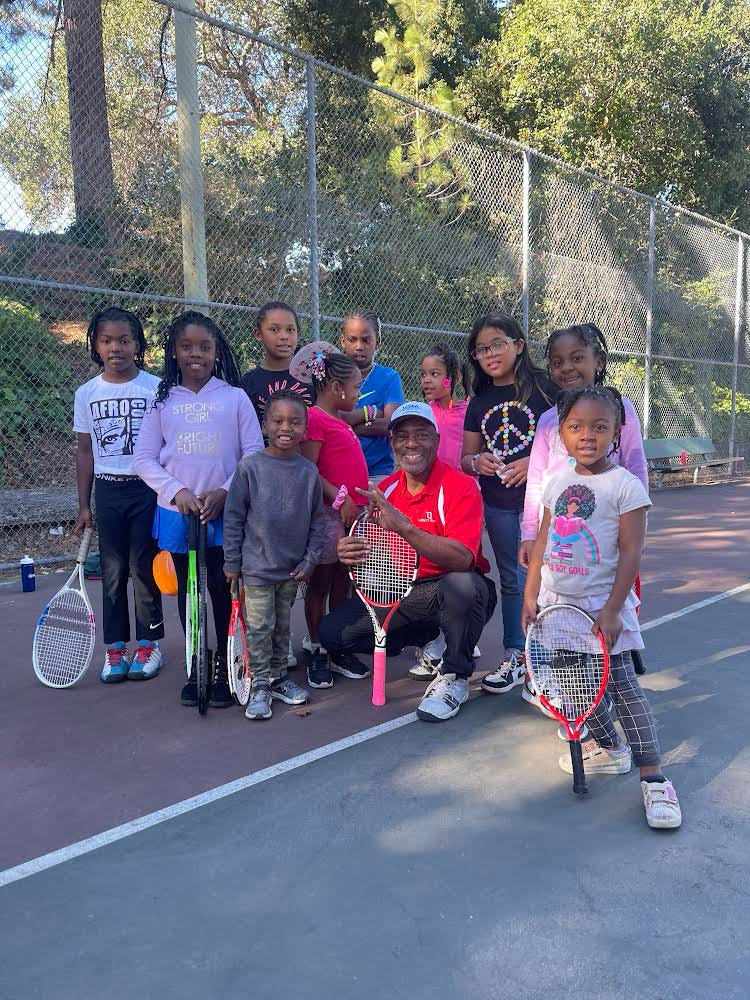 Community tennis participants outside